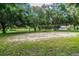 Sand volleyball court surrounded by mature trees at 775 Rolling Hills Dr, Palm Harbor, FL 34683