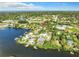 Aerial view of a waterfront home with lush landscaping and a private dock at 800 Missouri Ave, Palm Harbor, FL 34683