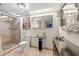 Contemporary bathroom with a glass shower, modern vanity, and unique artistic accents at 800 Missouri Ave, Palm Harbor, FL 34683