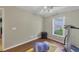 Bright room featuring hardwood floors, neutral walls, and a ceiling fan with natural light from the window at 816 Leeward Rd, Venice, FL 34293