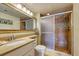 Bathroom with shower, granite vanity, and updated fixtures at 851 Bayway Blvd # 201, Clearwater, FL 33767