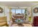 Bright sunroom with comfy seating and scenic views at 851 Bayway Blvd # 201, Clearwater, FL 33767