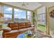 Bright sunroom with comfy couch and large windows at 851 Bayway Blvd # 201, Clearwater, FL 33767
