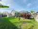 Landscaped backyard with shed and screened enclosure at 9625 Fox Hearst Rd, Tampa, FL 33647