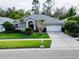 Single-story home with a two-car garage and well-manicured lawn at 9625 Fox Hearst Rd, Tampa, FL 33647