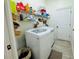 Bright laundry room with washer, dryer, and ample shelving at 9625 Fox Hearst Rd, Tampa, FL 33647