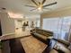 Open living area with hardwood floors, neutral colors and kitchen views at 9625 Fox Hearst Rd, Tampa, FL 33647