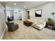 Living room with light beige couch, wood floor, and large windows at 9625 Fox Hearst Rd, Tampa, FL 33647