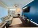 Living room with a blue accent wall, fireplace and large screen TV at 9625 Fox Hearst Rd, Tampa, FL 33647