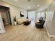 Living room with beige sectional, wood-look tile, and entryway view at 9625 Fox Hearst Rd, Tampa, FL 33647