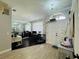 Home office with two workstations, mirror wall, and dark hardwood floors at 9625 Fox Hearst Rd, Tampa, FL 33647