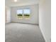 Bright bedroom featuring gray carpeting and dual windows at 9804 Crescent Moon Dr, Riverview, FL 33578
