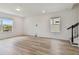Spacious bonus room with wood-look flooring and large windows at 9804 Crescent Moon Dr, Riverview, FL 33578