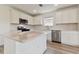 Modern kitchen with white cabinets, quartz countertops, and stainless steel appliances at 9804 Crescent Moon Dr, Riverview, FL 33578