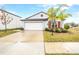 One-story home with white garage door and landscaping at 9805 Lemon Drop Loop, Sun City Center, FL 33573