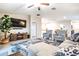 Spacious living area with plush seating, a large TV, and fireplace at 9805 Lemon Drop Loop, Sun City Center, FL 33573