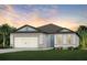 One-story home with a two-car garage and landscaped lawn at 9818 Crescent Moon Dr, Riverview, FL 33578