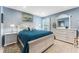 Charming bedroom with white furniture and teal bedding, near the bathroom at 1111 N Bayshore Blvd # B7, Clearwater, FL 33759