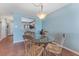 Dining area with glass-top table and four wicker chairs at 1111 N Bayshore Blvd # B7, Clearwater, FL 33759