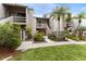 Condo building exterior with lush landscaping and walkway at 1111 N Bayshore Blvd # B7, Clearwater, FL 33759