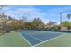 Well-maintained tennis court with green surroundings at 1111 N Bayshore Blvd # B7, Clearwater, FL 33759