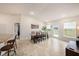 Bright dining room with large windows, wooden table, and kitchen access at 11521 Sunder Berry St, Hudson, FL 34667