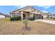 House exterior showcasing a two-car garage and manicured lawn at 11521 Sunder Berry St, Hudson, FL 34667