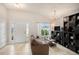 Bright living room with tiled floors, sofa, and built-in shelving at 11521 Sunder Berry St, Hudson, FL 34667