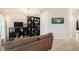 Cozy living room featuring a brown sofa and a black shelving unit at 11521 Sunder Berry St, Hudson, FL 34667