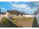 Spacious backyard with a grassy area and white fence at 11536 Tangle Stone Dr, Gibsonton, FL 33534