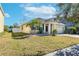 House exterior with palm trees and a well-maintained lawn at 11536 Tangle Stone Dr, Gibsonton, FL 33534