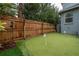 Private backyard with putting green and wooden fence at 117 W Minnehaha St, Tampa, FL 33604