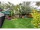 Landscaped backyard with artificial turf and playset at 117 W Minnehaha St, Tampa, FL 33604