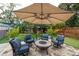 Outdoor patio furniture under an umbrella, artificial turf, and putting green at 117 W Minnehaha St, Tampa, FL 33604