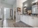 Elegant bathroom with double vanity, granite countertop, and gray walls at 117 W Minnehaha St, Tampa, FL 33604