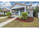 Gray craftsman home with a light teal door, landscaping, and a walkway at 117 W Minnehaha St, Tampa, FL 33604