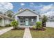 Gray craftsman home with a light teal door, landscaping, and a walkway at 117 W Minnehaha St, Tampa, FL 33604