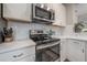 Modern kitchen with stainless steel appliances and white cabinets at 117 W Minnehaha St, Tampa, FL 33604