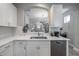 Kitchen with white cabinets, quartz countertops, and stainless steel dishwasher at 117 W Minnehaha St, Tampa, FL 33604