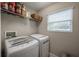 Laundry room with washer, dryer, and shelving for storage at 117 W Minnehaha St, Tampa, FL 33604