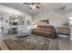 Open living room with brown leather couches and a ceiling fan at 117 W Minnehaha St, Tampa, FL 33604