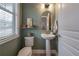 Small powder room features a pedestal sink and updated fixtures at 117 W Minnehaha St, Tampa, FL 33604