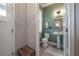 Stylish powder room with pedestal sink, toilet, and green walls at 117 W Minnehaha St, Tampa, FL 33604