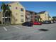 Apartment building with parking lot and palm trees at 11901 4Th N St # 10105, St Petersburg, FL 33716