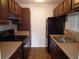 Galley kitchen with dark wood cabinets and appliances at 11901 4Th N St # 10105, St Petersburg, FL 33716