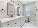 Modern bathroom with double vanity, quartz countertop, and walk-in shower at 1210 E Mohawk Ave, Tampa, FL 33604