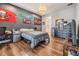 Guest bedroom with dark wood dresser and a full-size bed at 1210 E Mohawk Ave, Tampa, FL 33604