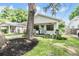 Charming craftsman bungalow with a covered porch, landscaped yard, and brick accents at 1210 E Mohawk Ave, Tampa, FL 33604