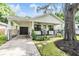 Craftsman style home with covered front porch and brick details at 1210 E Mohawk Ave, Tampa, FL 33604