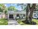 House exterior showcasing a paved driveway and modern garage door at 1210 E Mohawk Ave, Tampa, FL 33604